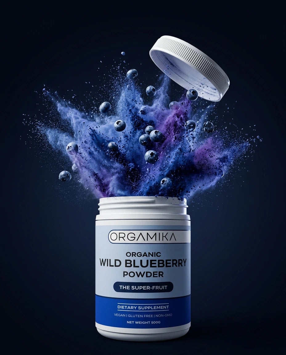 ORGAMIKA Wild Blueberry Powder tub in a burst of deep blue-violet powder and whole blueberries